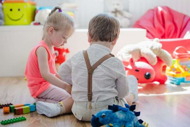 children-sitting-on-floor-in-playroom